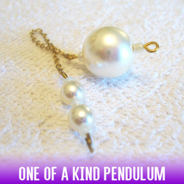 A dowsing pendulum with round imitation pearl bead and an easy-to-hold handle on a gold chain. Simplicity at its best.