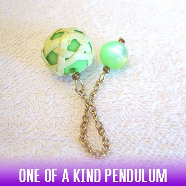 A lime green acrylic sphere dowsing pendulum in a white rattan knit style and a gold chain