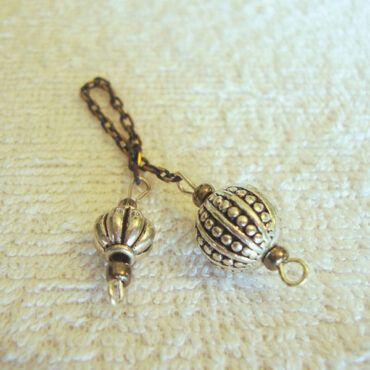 A Silver Alloy Ball Pendulum with a Pumpkin Handle on an Antique Chain