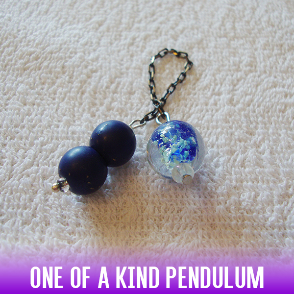 Clear round pendulum with blue & white bubbles and a double ball handle and antique chain