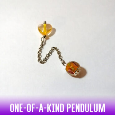 A one-of-a-kind round dowsing pendulum of amber rose Murano glass bead with a heart-shaped glass bead handle on an antique style silver chain
