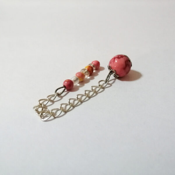 A dowsing pendulum of petite pink, red and and yellow colored stone beads with a long handle of 7 petite colored stones and clear acrylic beads with a silver chain.