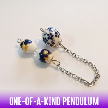 A one-of-a-kind porcelain bead dowsing pendulum with vintage hand-painted blue flowers on a silver chain with silver end caps. On the handle, the 2 oval ceramic beads which are also hand-painted with blue-yellow flowers and the small central bead, make the grip stable and comfortable. A very classically aristocratic feel for a truly feminine dowser. 