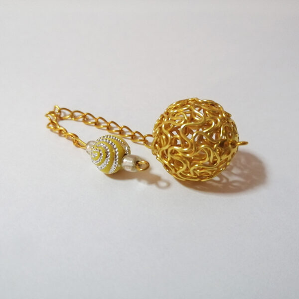 A popular dowsing pendulum of a bright golden hollow twist wire ball, with an acrylic bright yellow acrylic bead handle with silver details on a gold chain