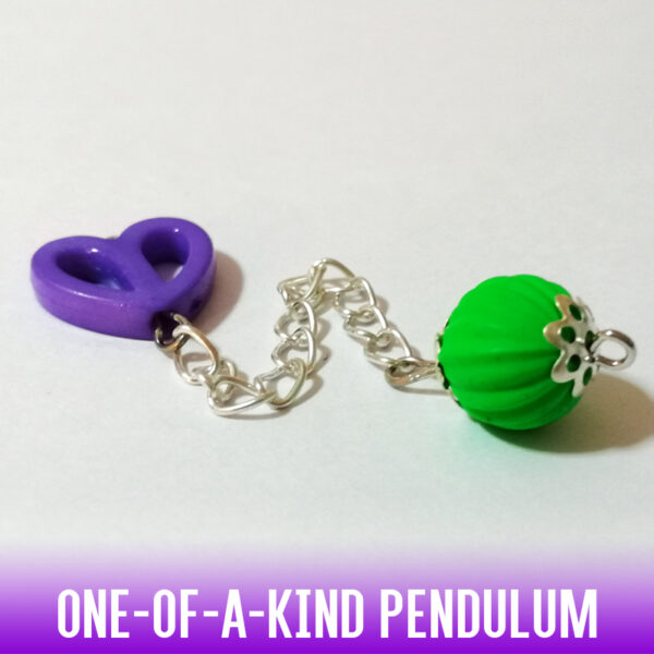 A one-of-a-kind dowsing pendulum with an acrylic, matte neon green corrugated rubber bead on a silver chain with silver end caps. On the handle, we have a bright mauve hollow acrylic heart bead. A fun dowsing tool for the young or the young at heart.